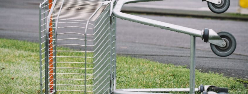 Verlassener Einkaufswagen auf Gras