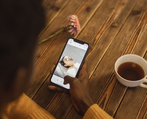 Person nutzt Dating-App am Smartphone